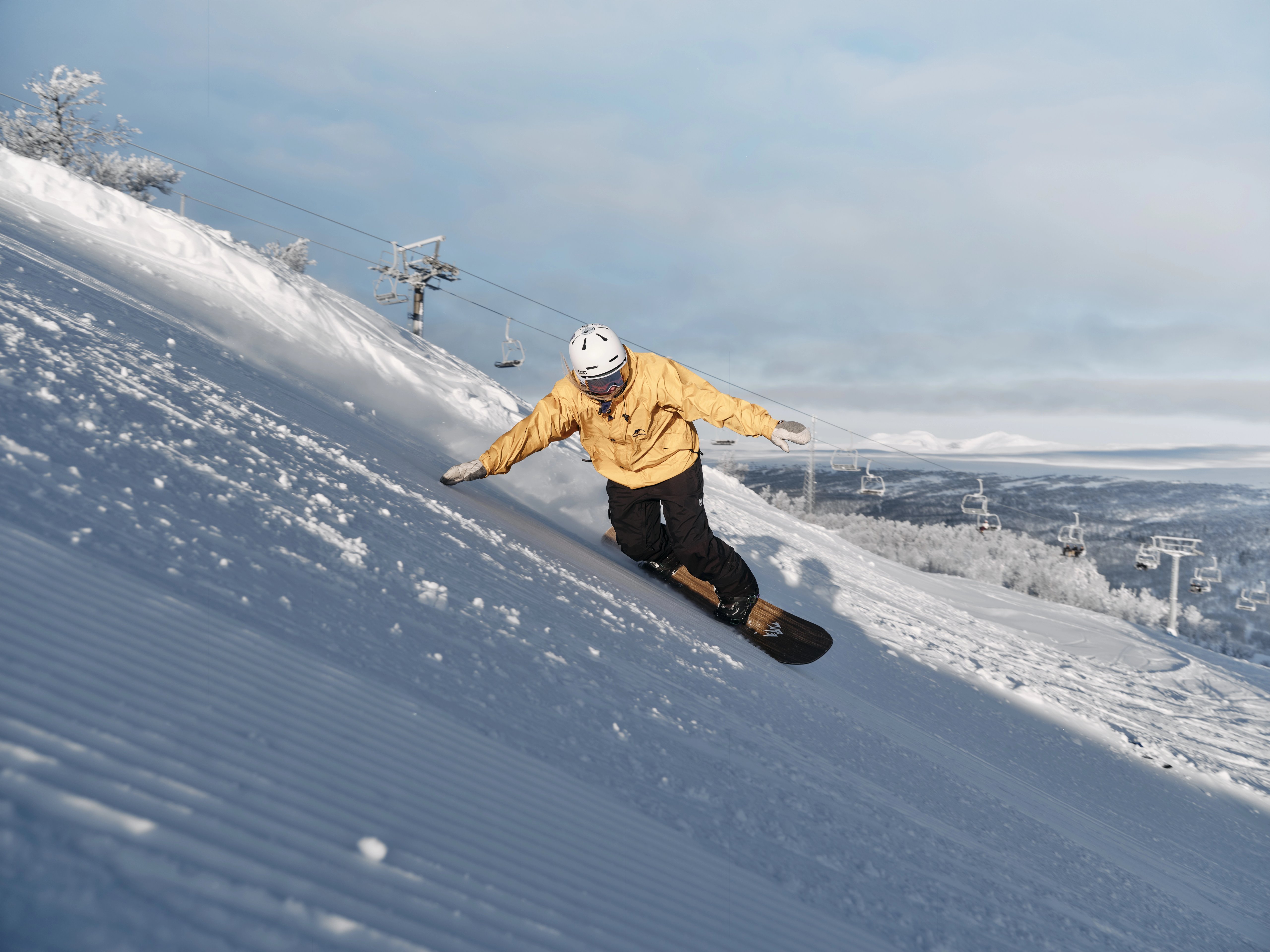 A woman snowboarding down a ski slope.