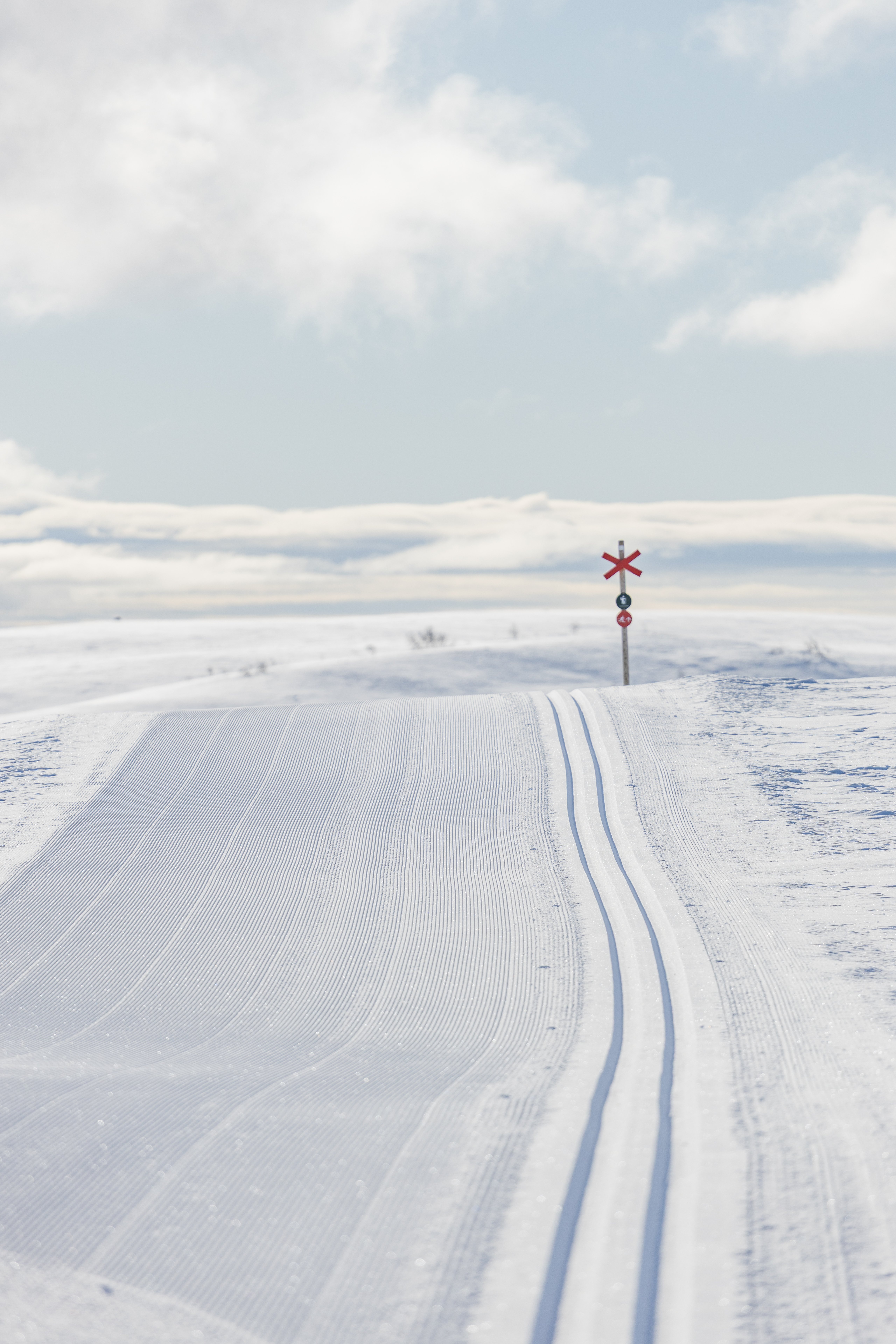 A freshly groomed cross-country ski trail in the mountains.