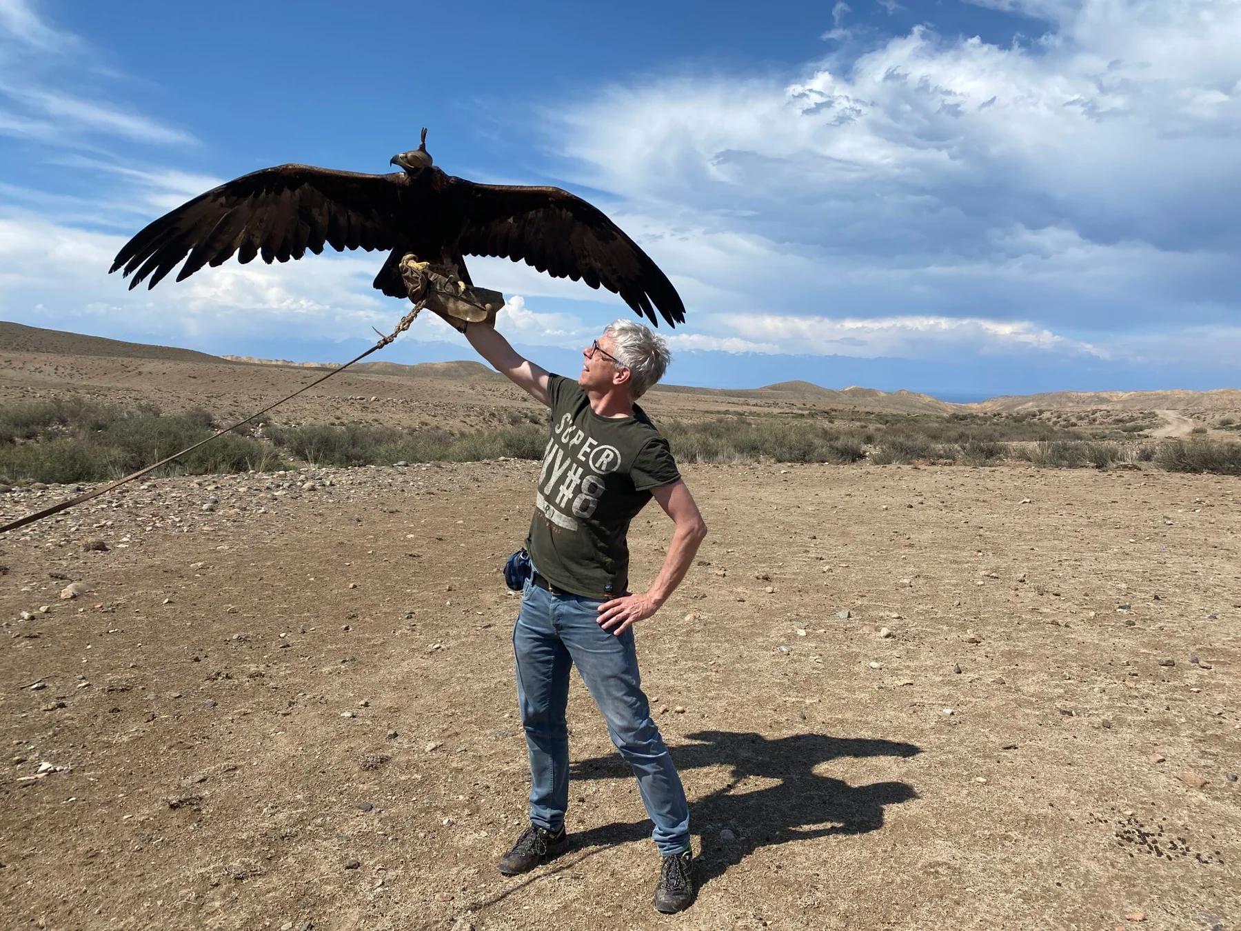 A traveller holding a Kyrgyz eagle