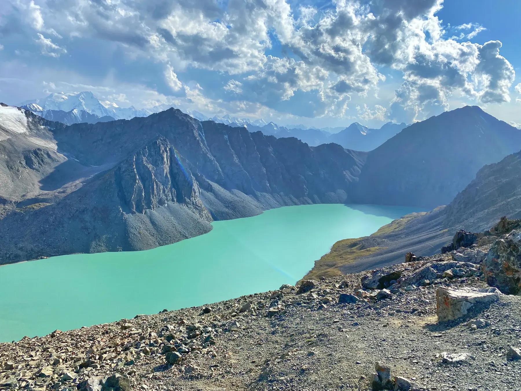 Turquoise Ala-Kol lake below a mountain pass