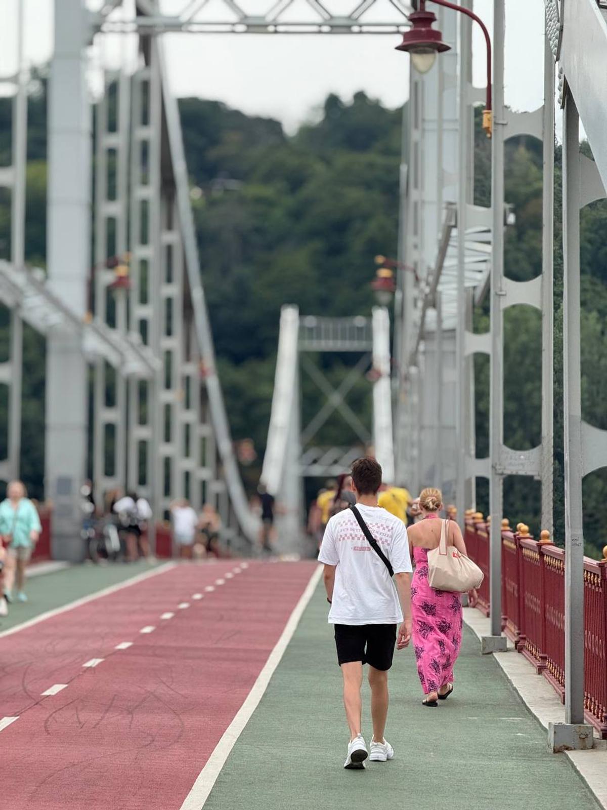 Pavlo walking in the Truhanov Pedestrian Bridge over the River Dnipro