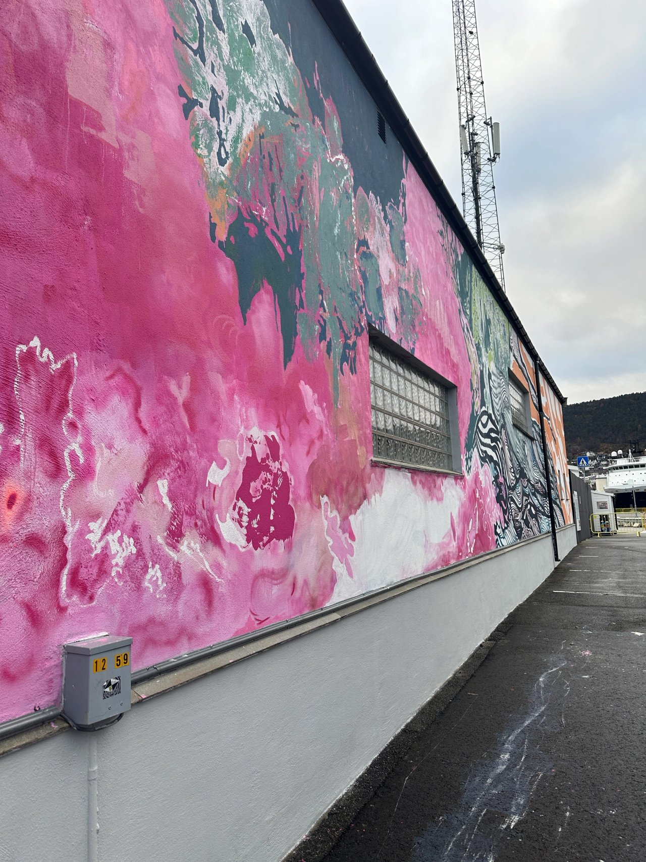 A gray brick wall has been transformed into a colorful artwork