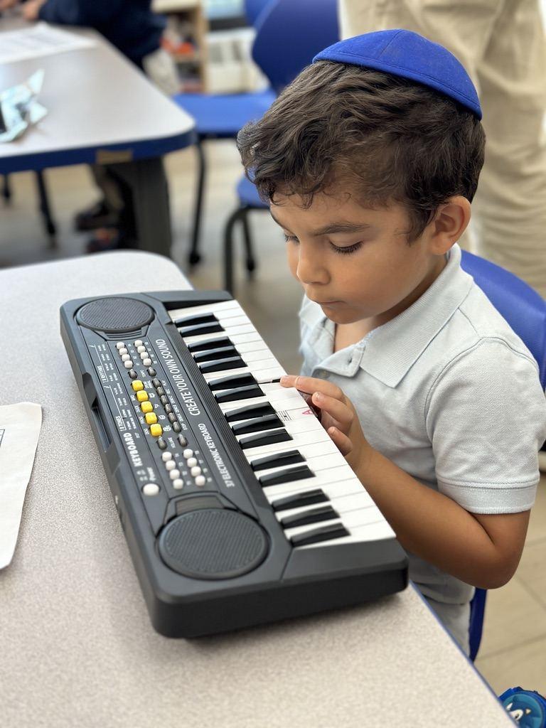 A student playing the keyboard in music