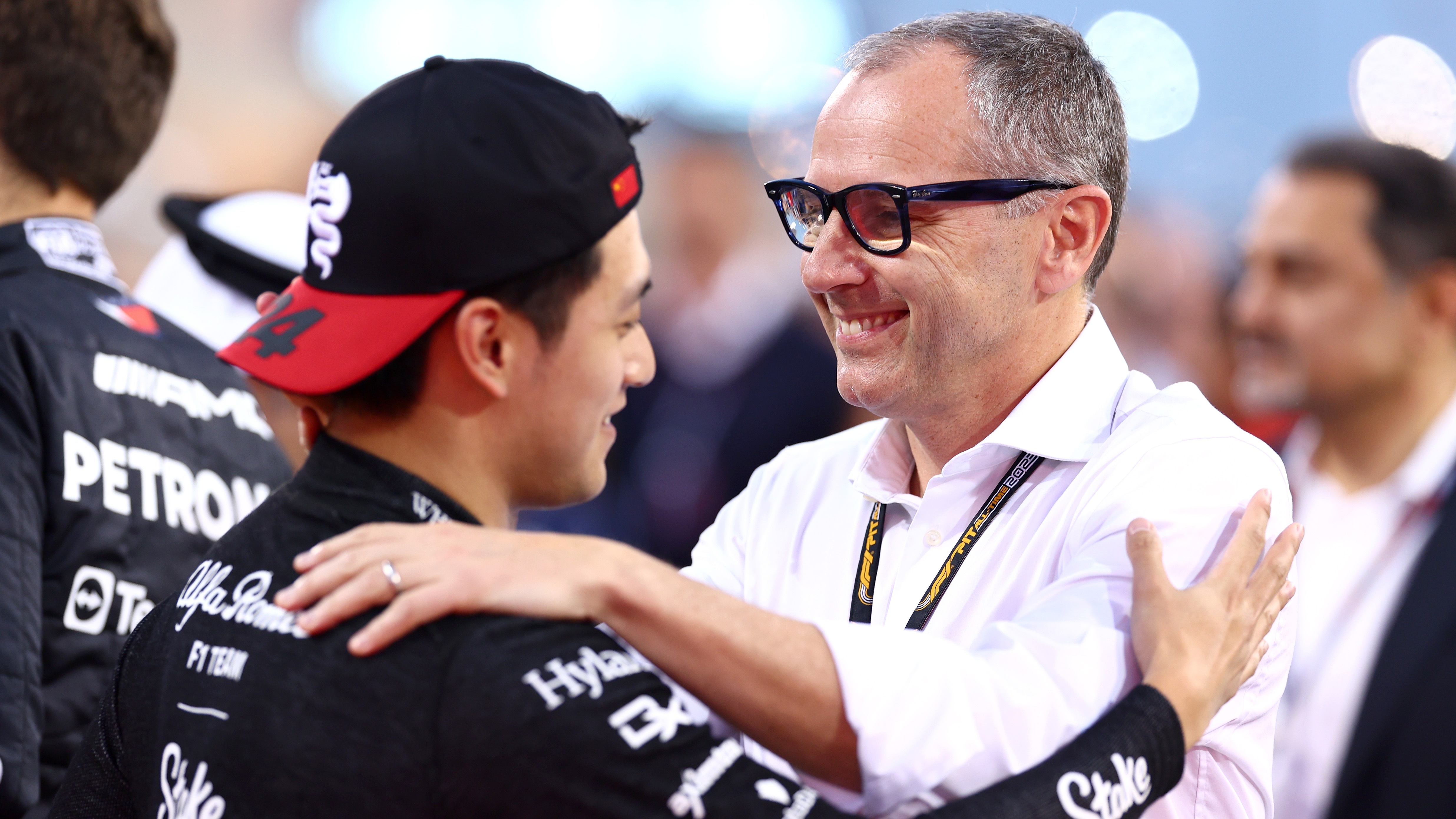 Stefano Domenicali, CEO of the Formula One Group, talks with Zhou Guanyu of China and Alfa Romeo F1 on the grid during the F1 Grand Prix of Bahrain at Bahrain International Circuit on March 5, 2023 in Bahrain. Image: Getty Images