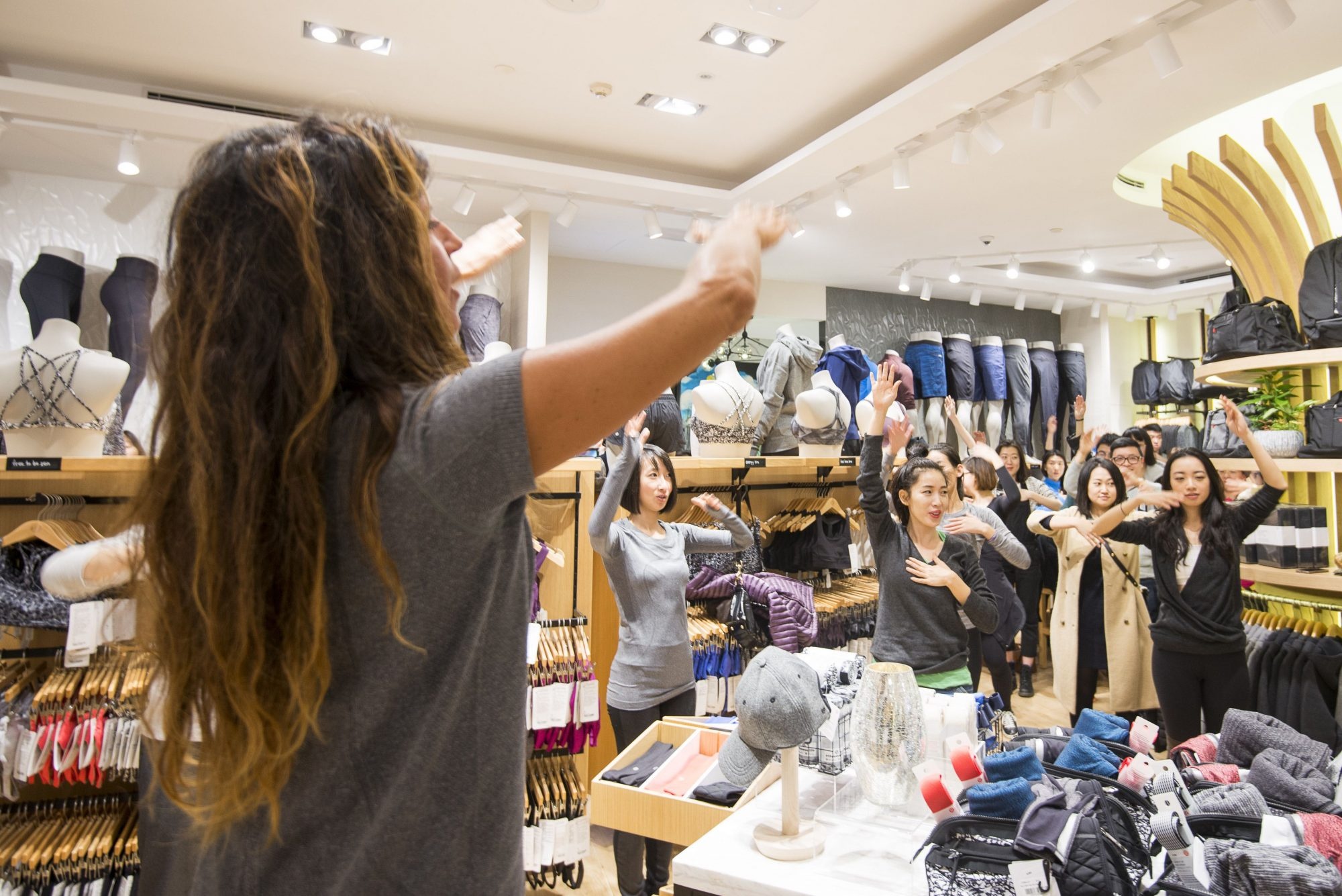 Guests participate in a group workout at the Lululemon store opening in Shanghai's IFC Mall. (Courtesy Photo)