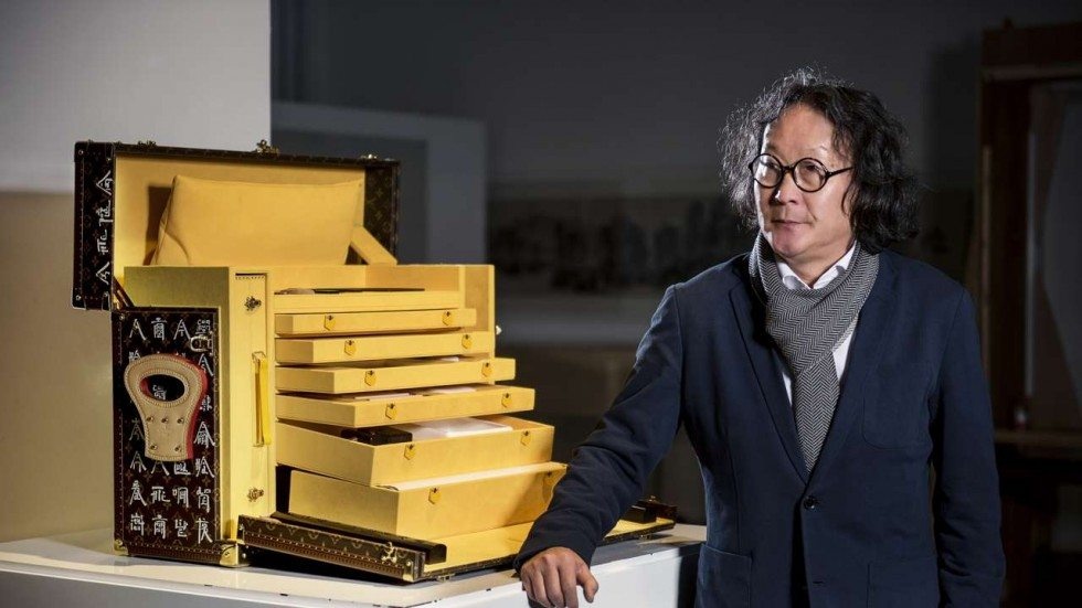 Xu Bing with the trunk he designed for Louis Vuitton. (Louis Vuitton)