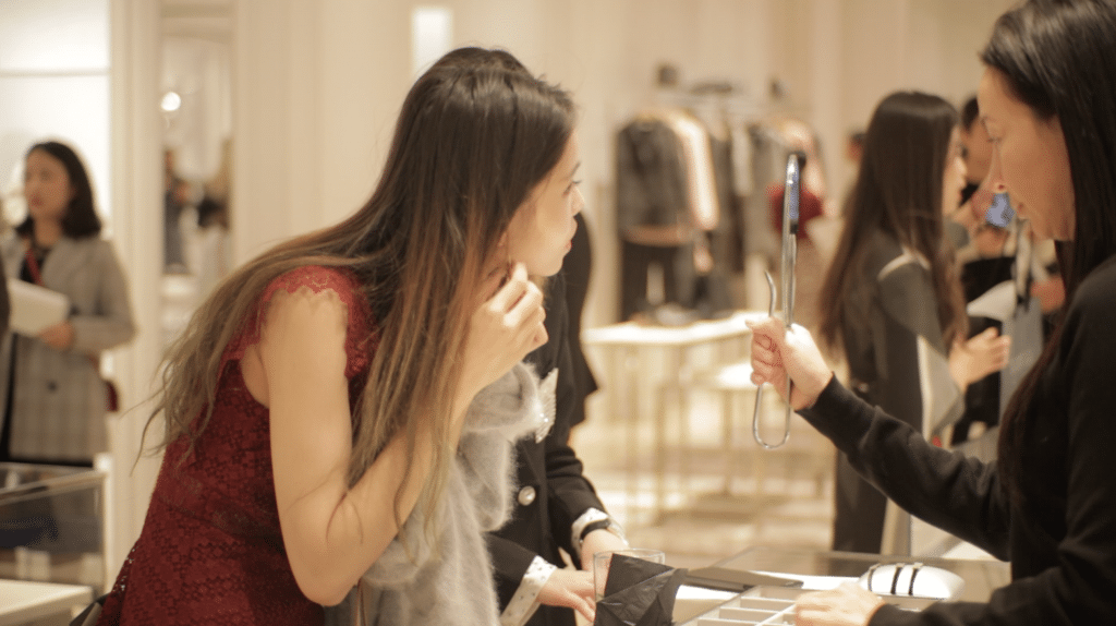 One of the students trying on earrings from Dior.