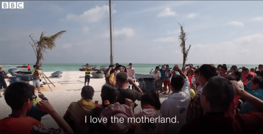 The flag raising ceremony is one of the highlights of trips to the South China Sea. (screen capture from the BBC)