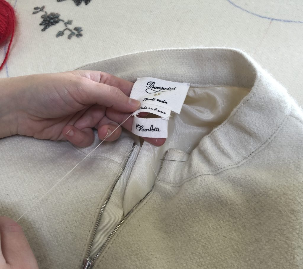 "What it means is the excellence, the research for the quality, and security," says Leclercq. "I mean the fabrics, the buttons, the details. We are really the reference for Chinese women." Photo: A tailor is sawing clothes at Bonpoint's Paris contour studio.