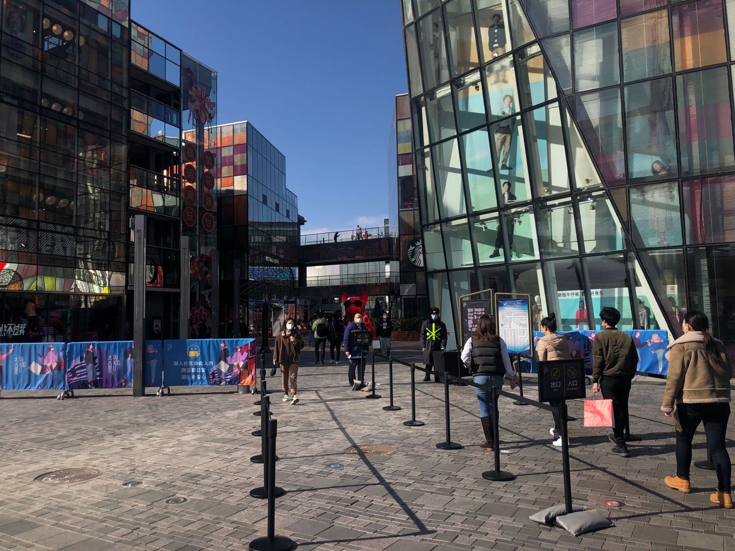 Shoppers entering into Sanlitun shopping area need to get their temperature checked. Photo: Jing Daily/Ruonan Zheng