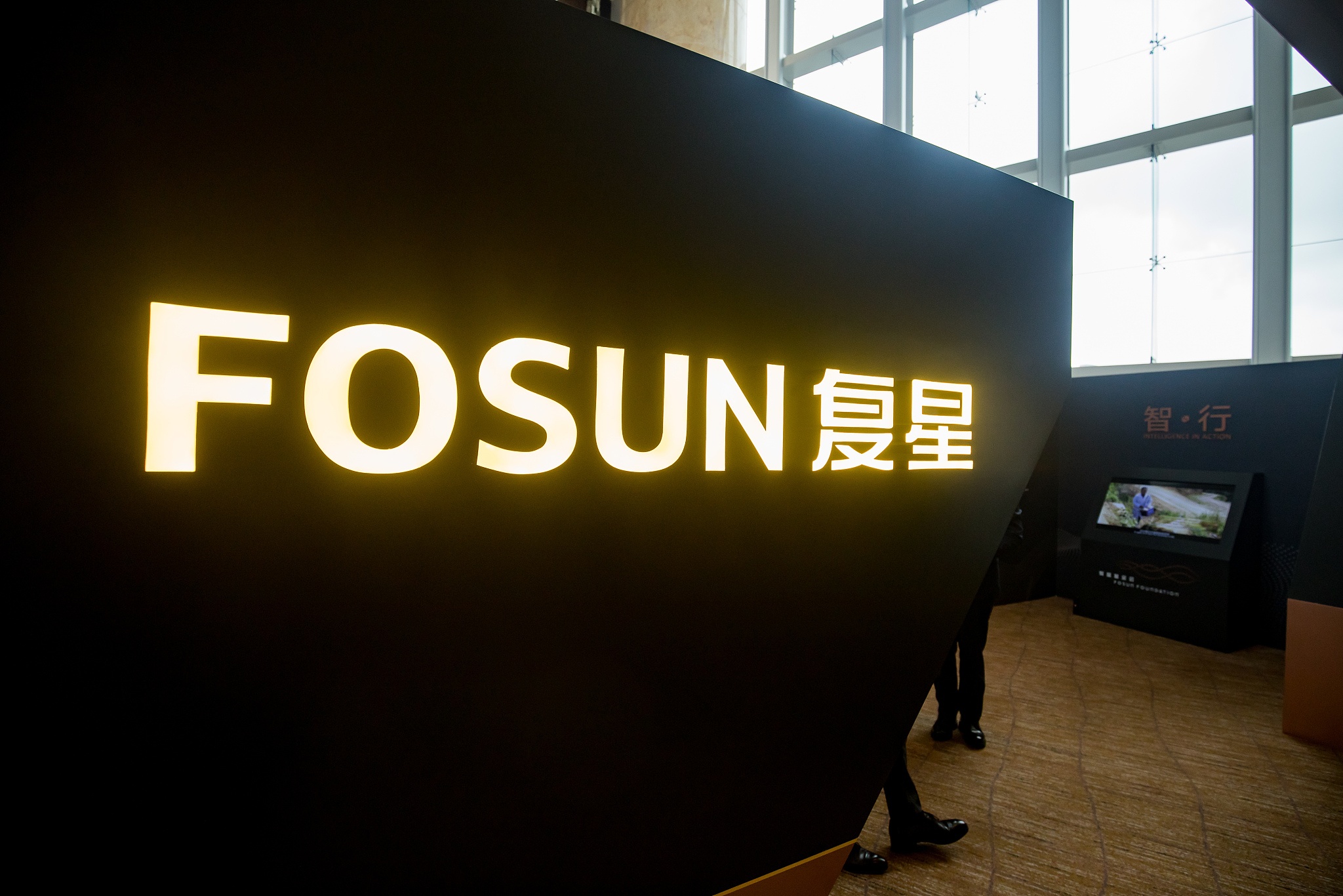 Fosun International Ltd. branding is displayed in an exhibition area during a news conference in Hong Kong, China, on Wednesday, Aug. 29, 2018. Fosun, the last of China's serial acquirers buying high-profile assets, reported higher profits amid gains from its investment division. Photographer: Paul Yeung/Bloomberg