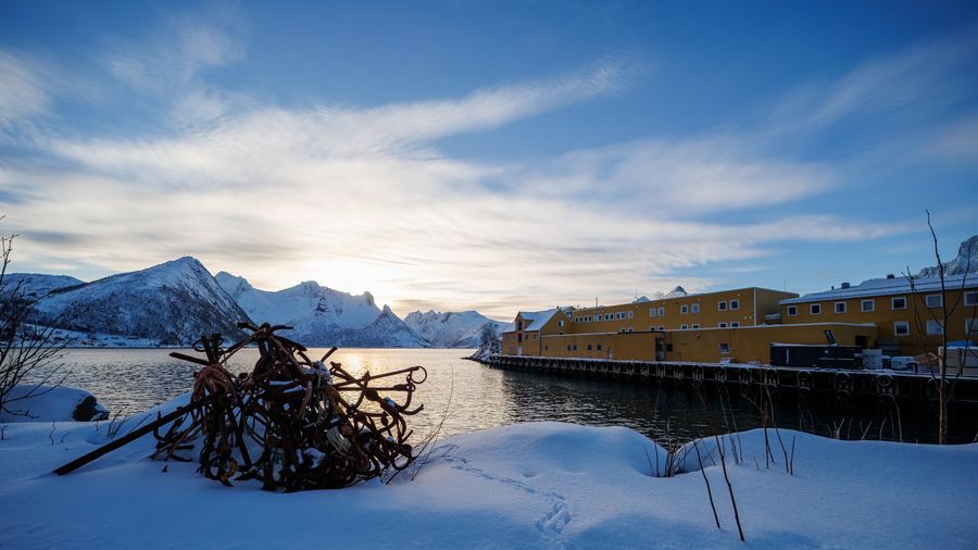 Gerät im Schnee, Sonne über dem Fjord