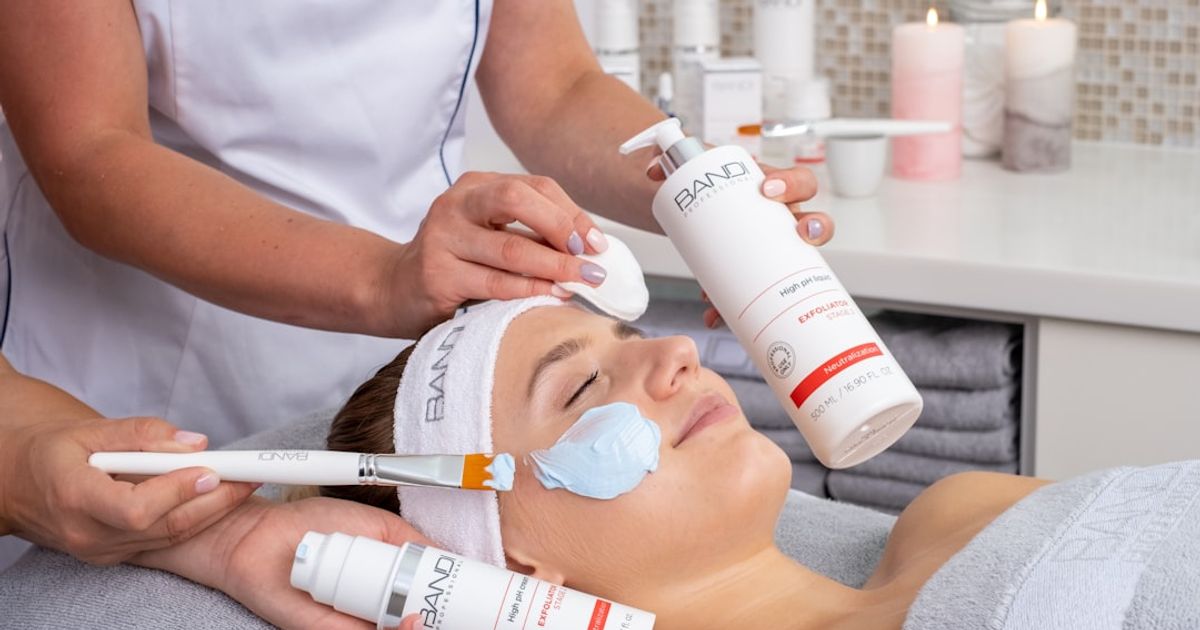 a woman getting a facial mask on her face