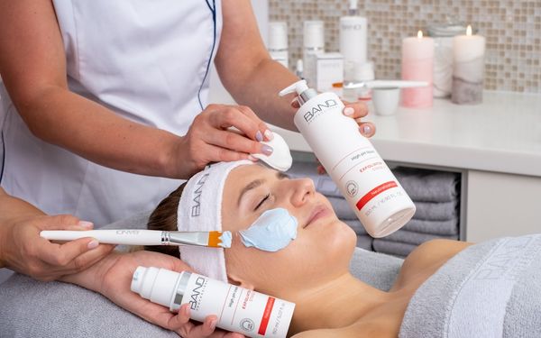 a woman getting a facial mask on her face