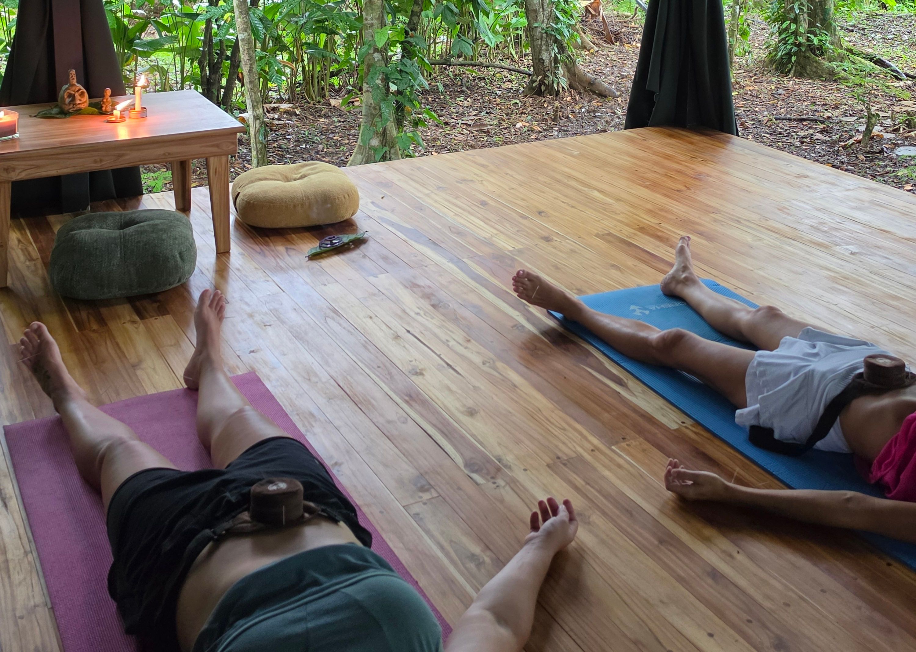 Moxa warming points on a client's back in the outdoor studio