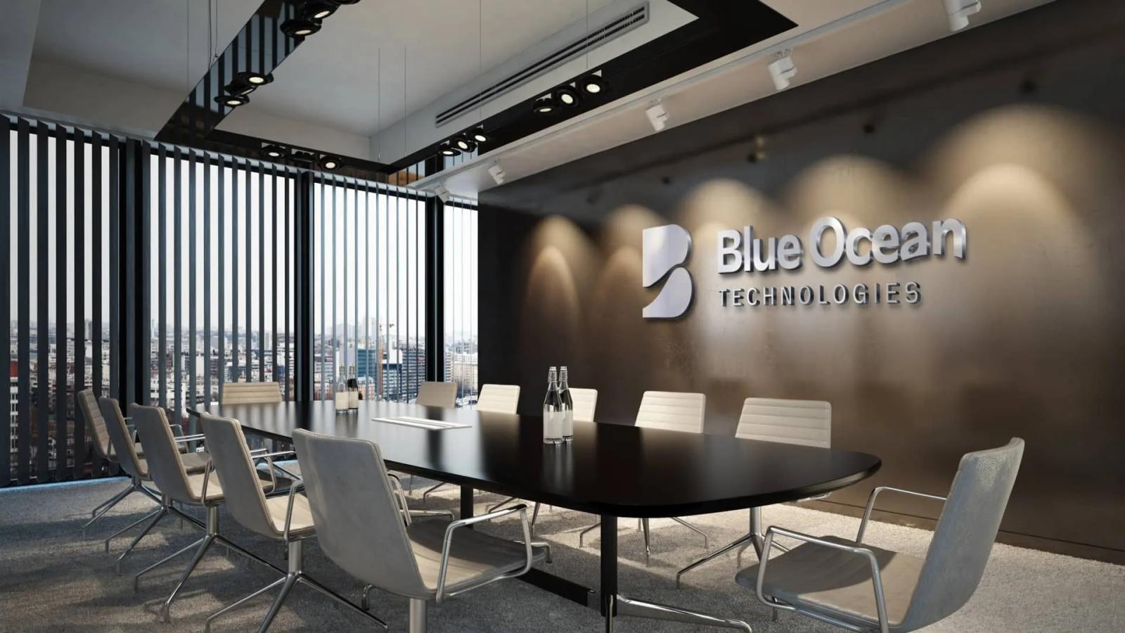 Sala de reuniones corporativa con el logotipo 3D metálico de Blue Ocean Technologies en la pared y una mesa de conferencias rodeada de sillas modernas en un entorno de oficina iluminado