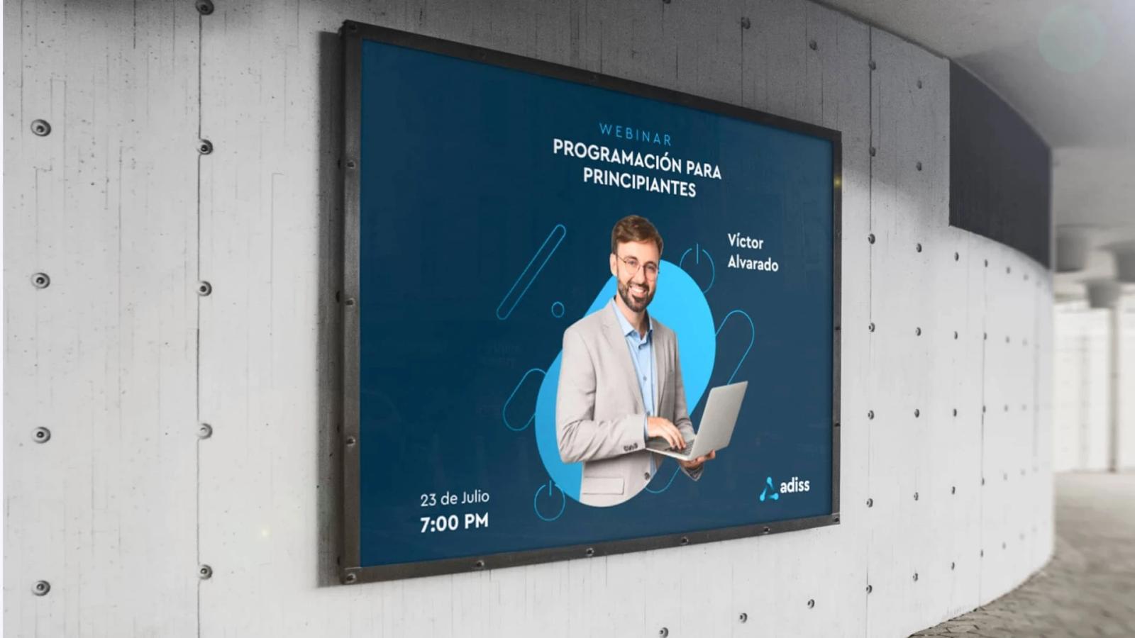 Mockup de cartel publicitario exterior de Adiss sobre pared de concreto anunciando el webinar Programación para Principiantes con Víctor Alvarado y fecha del evento
