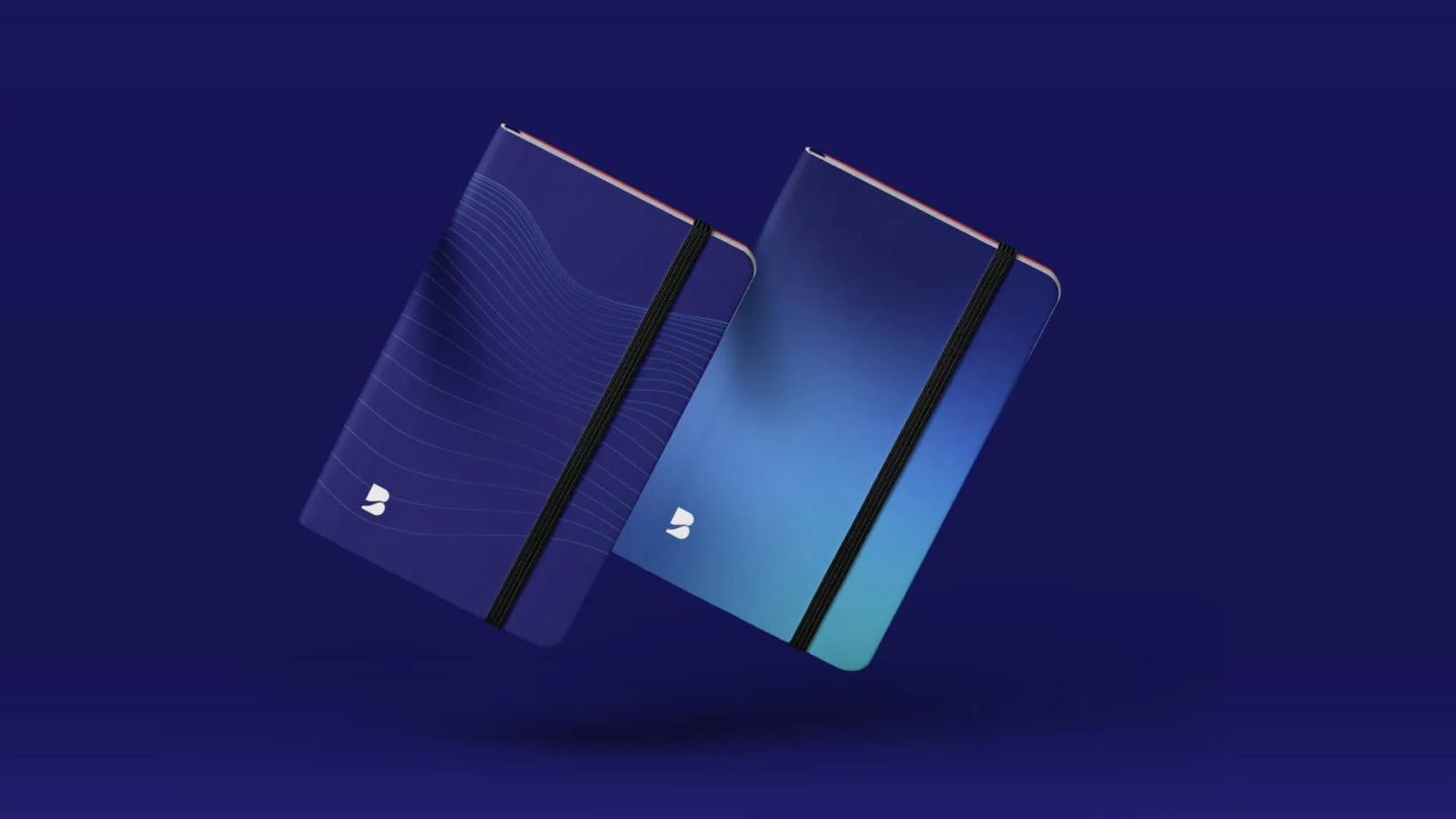 Dos cuadernos corporativos de Blue Ocean Technologies flotando en el aire con diseños de ondas lineales y degradado en tonos azules y cyan sobre fondo oscuro