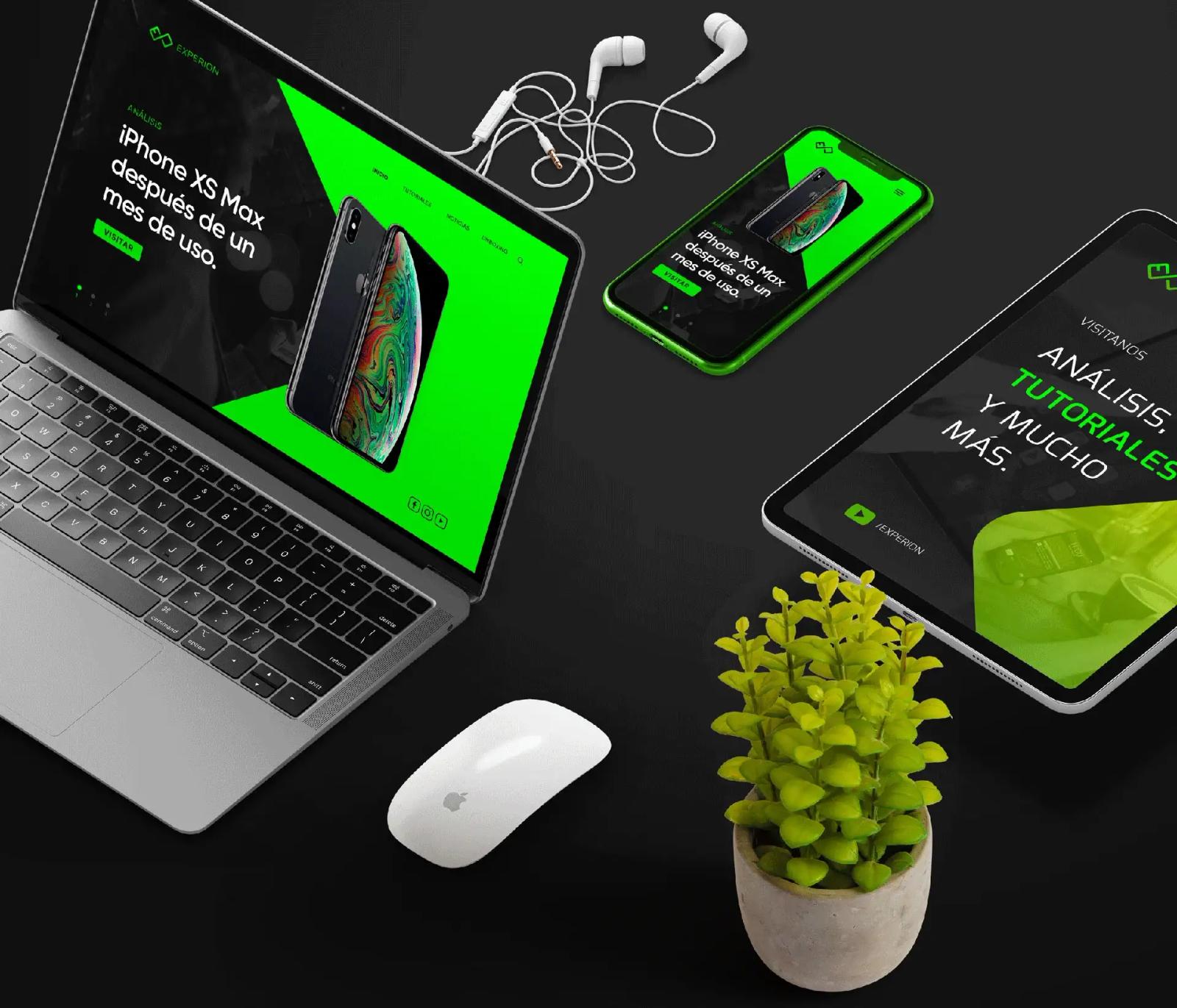 Laptop abierta mostrando interfaz tecnológica verde con accesorios y móviles sobre escritorio oscuro