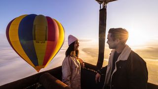 Couple enjoys views over Camden during a hot air balloon flight.