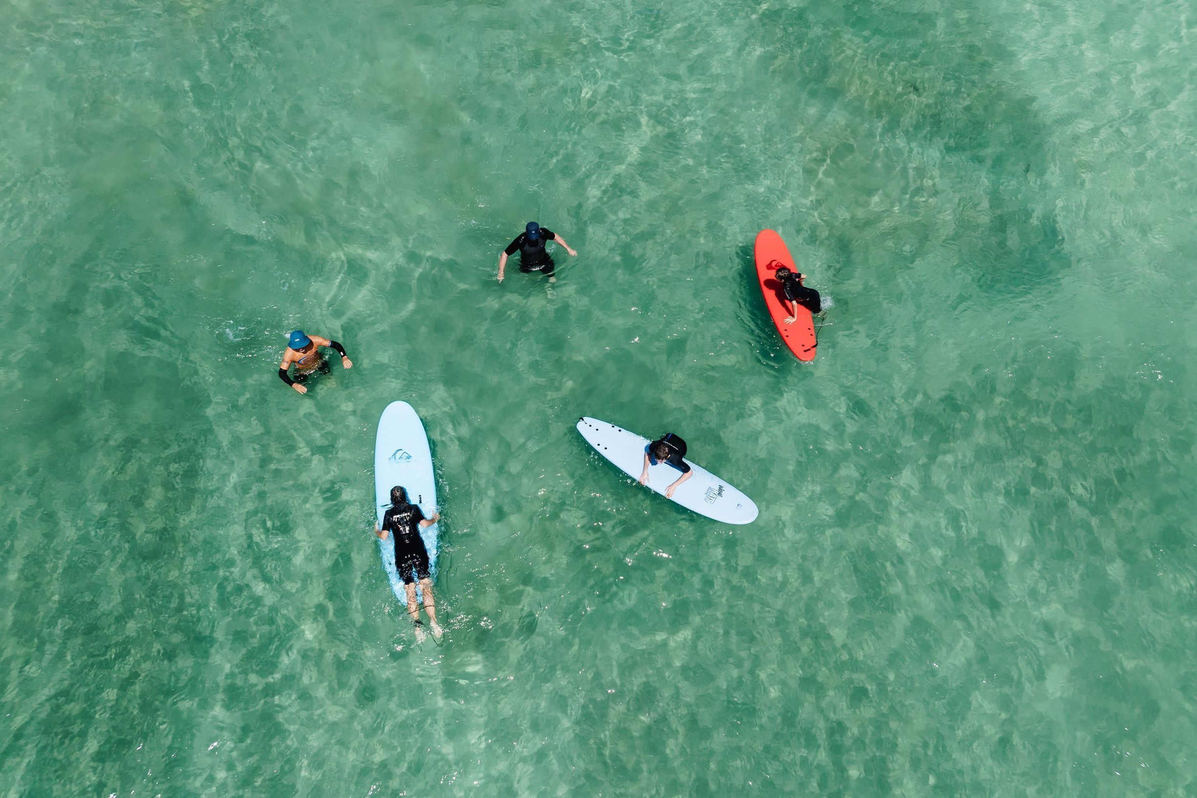 Family having a surf lesson