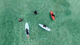 Family having a surf lesson