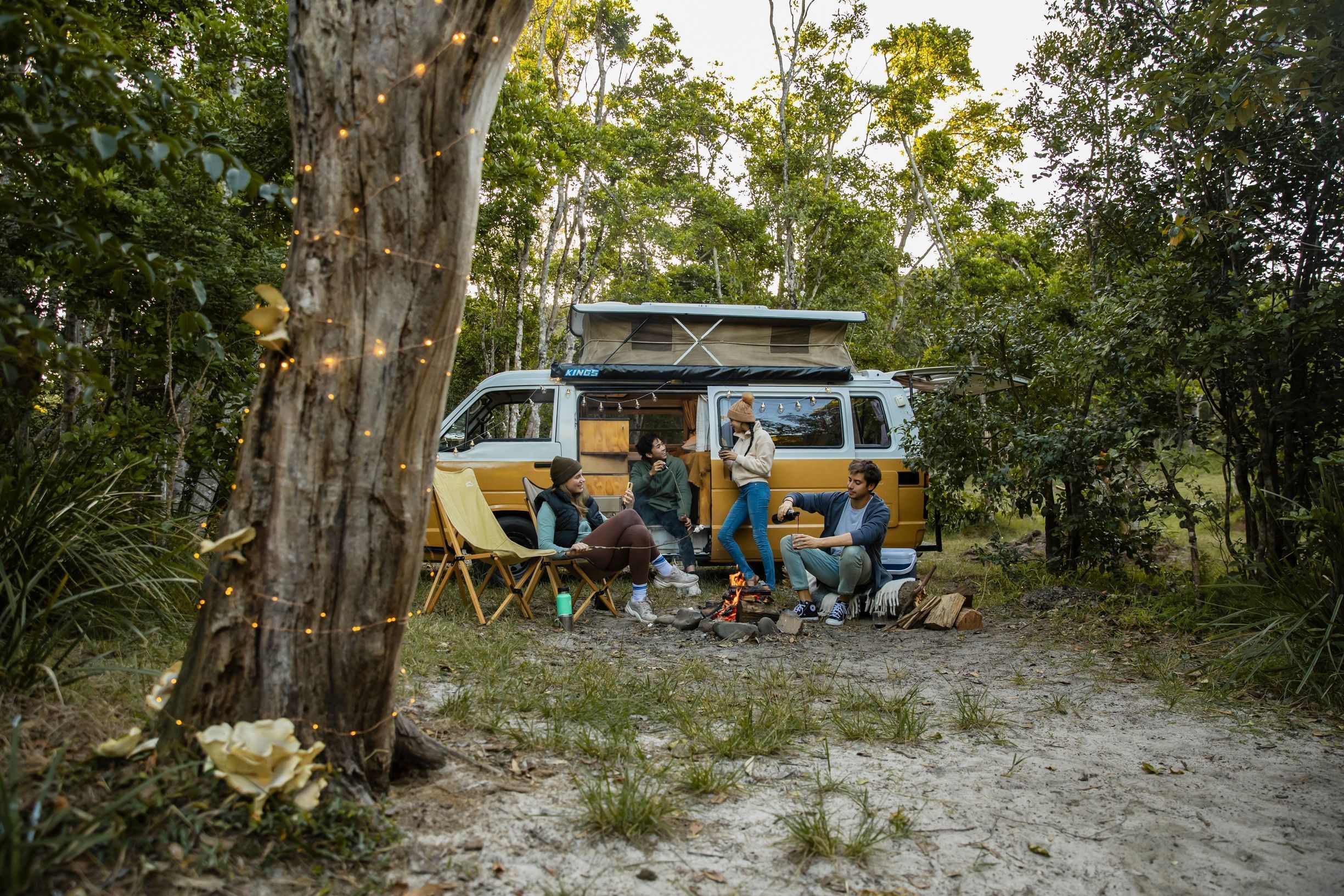 Young people relaxing by the campfire at Waves Campground in Crescent Head