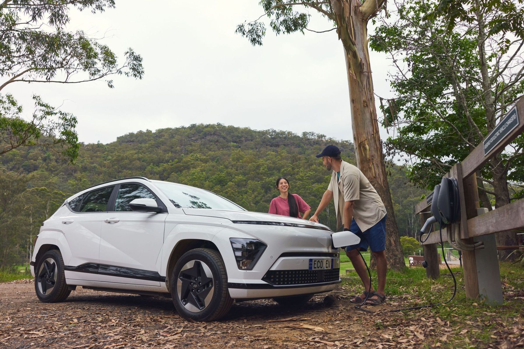 Couple charging their electric vehicle in regional NSW