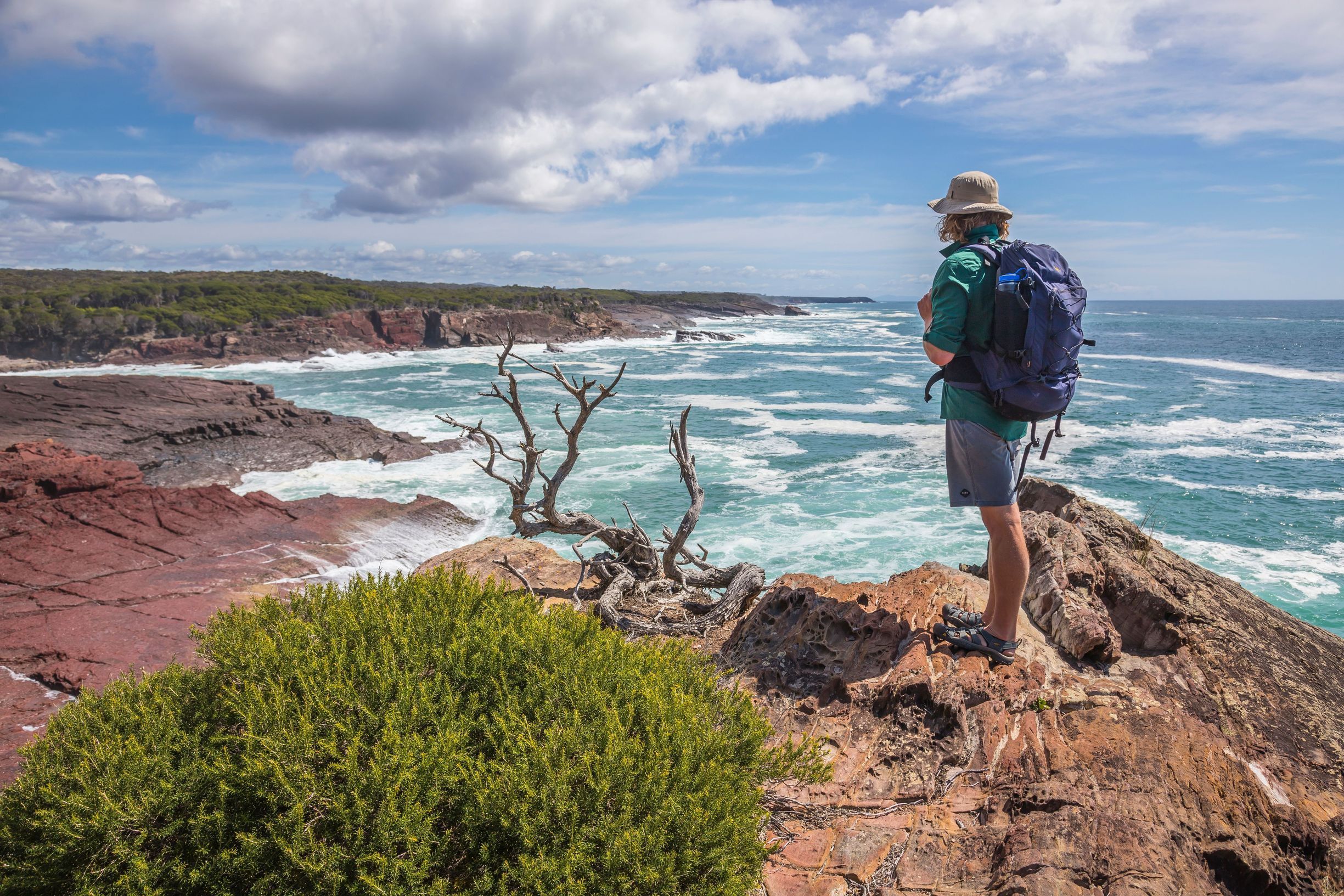 Man enjoying the scenic coastal views from Pulpit Rock in Beowa National Park.
