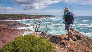Man enjoying the scenic coastal views from Pulpit Rock in Beowa National Park.
