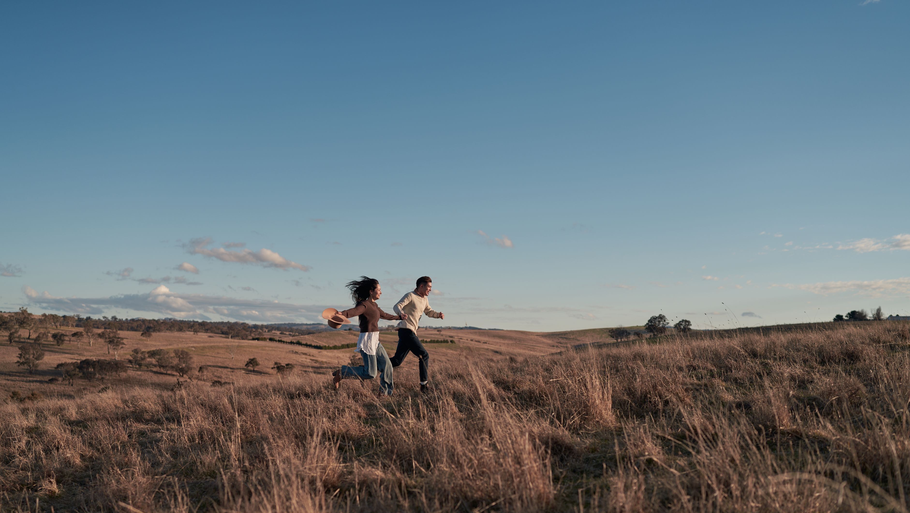 Couple running in field