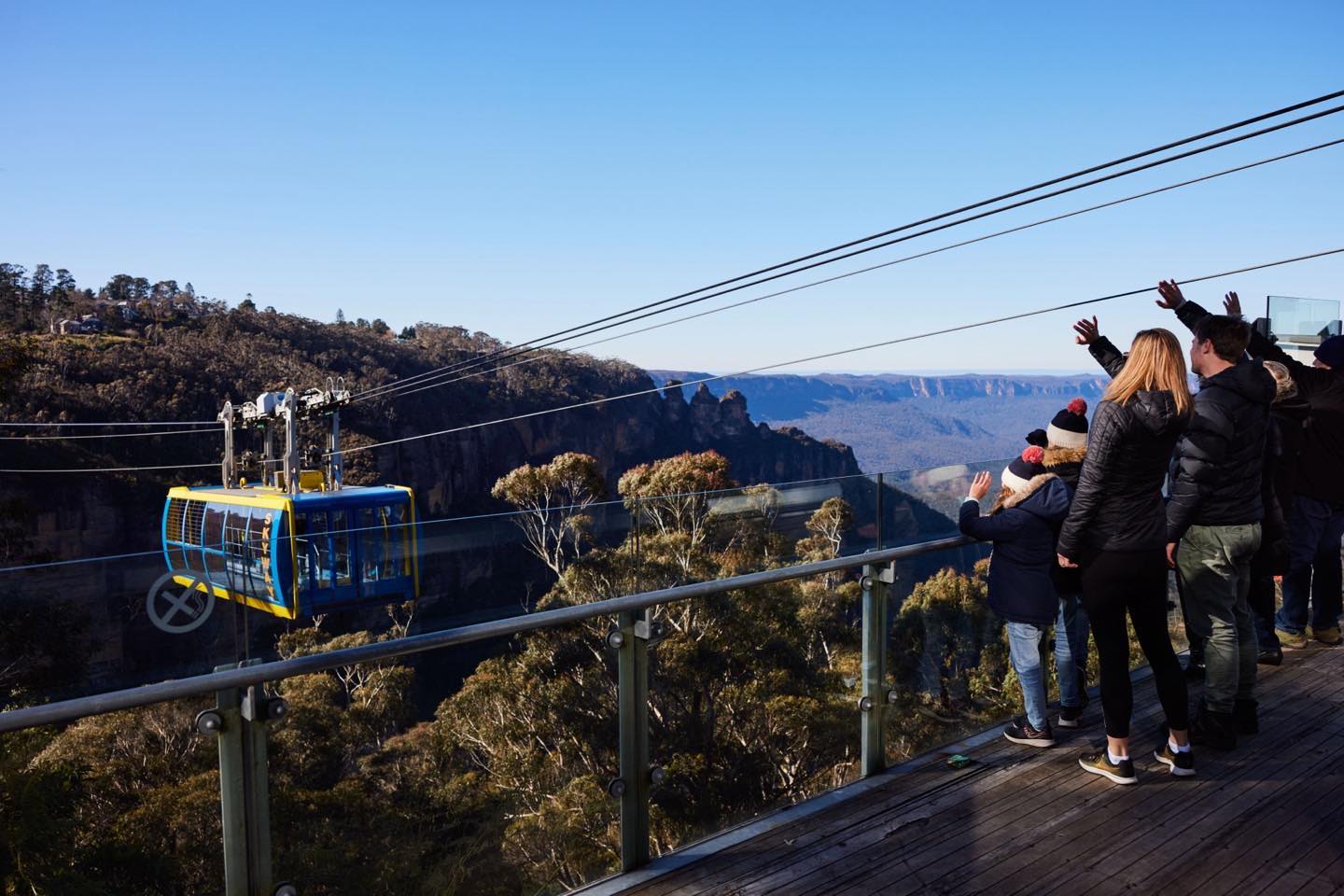 Family waving to people on skyway