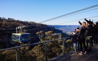 Family waving to people on skyway