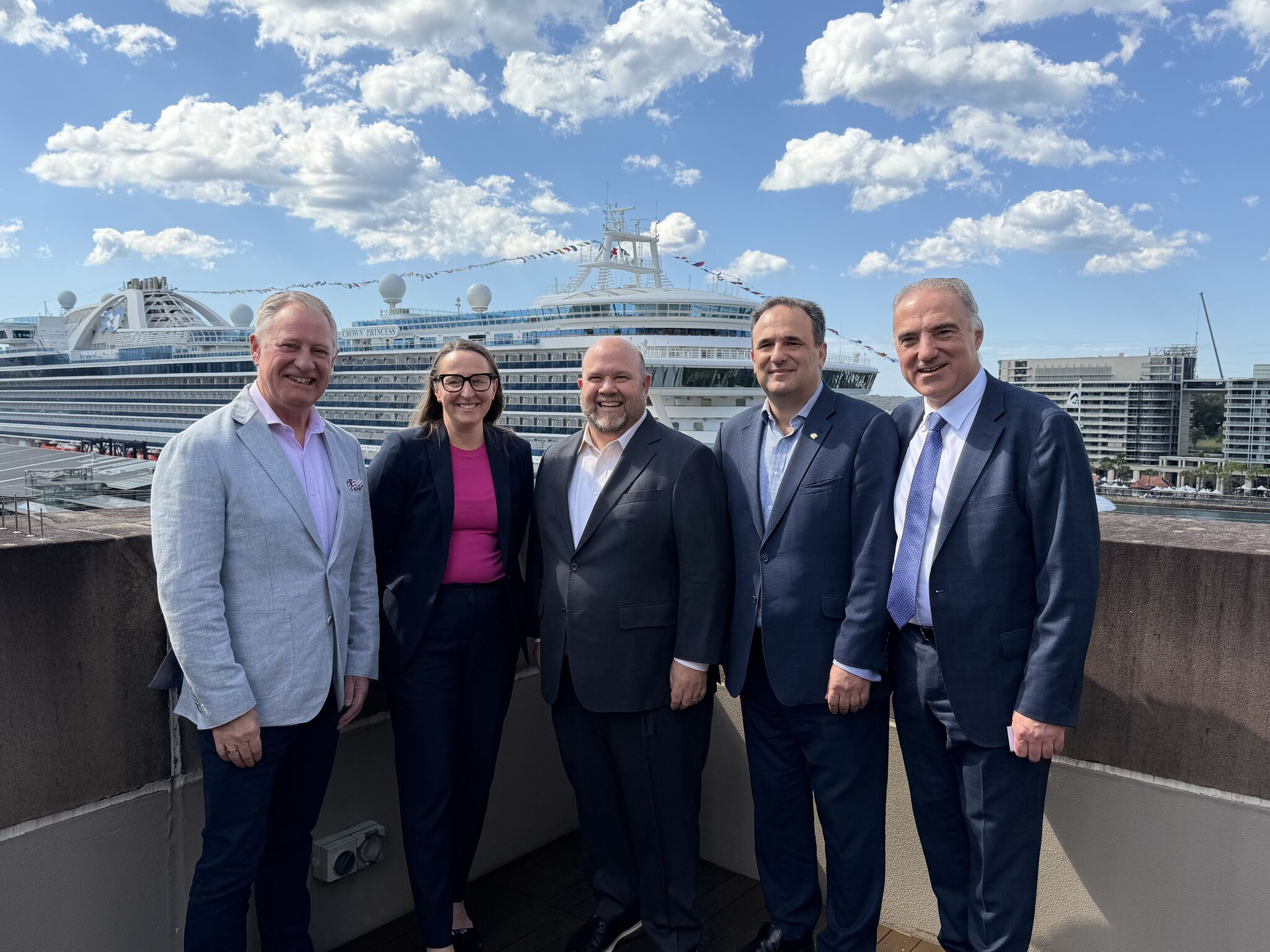 Industry leaders at MCA with cruise ship in background