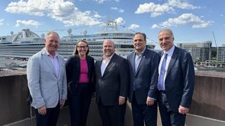 Industry leaders at MCA with cruise ship in background