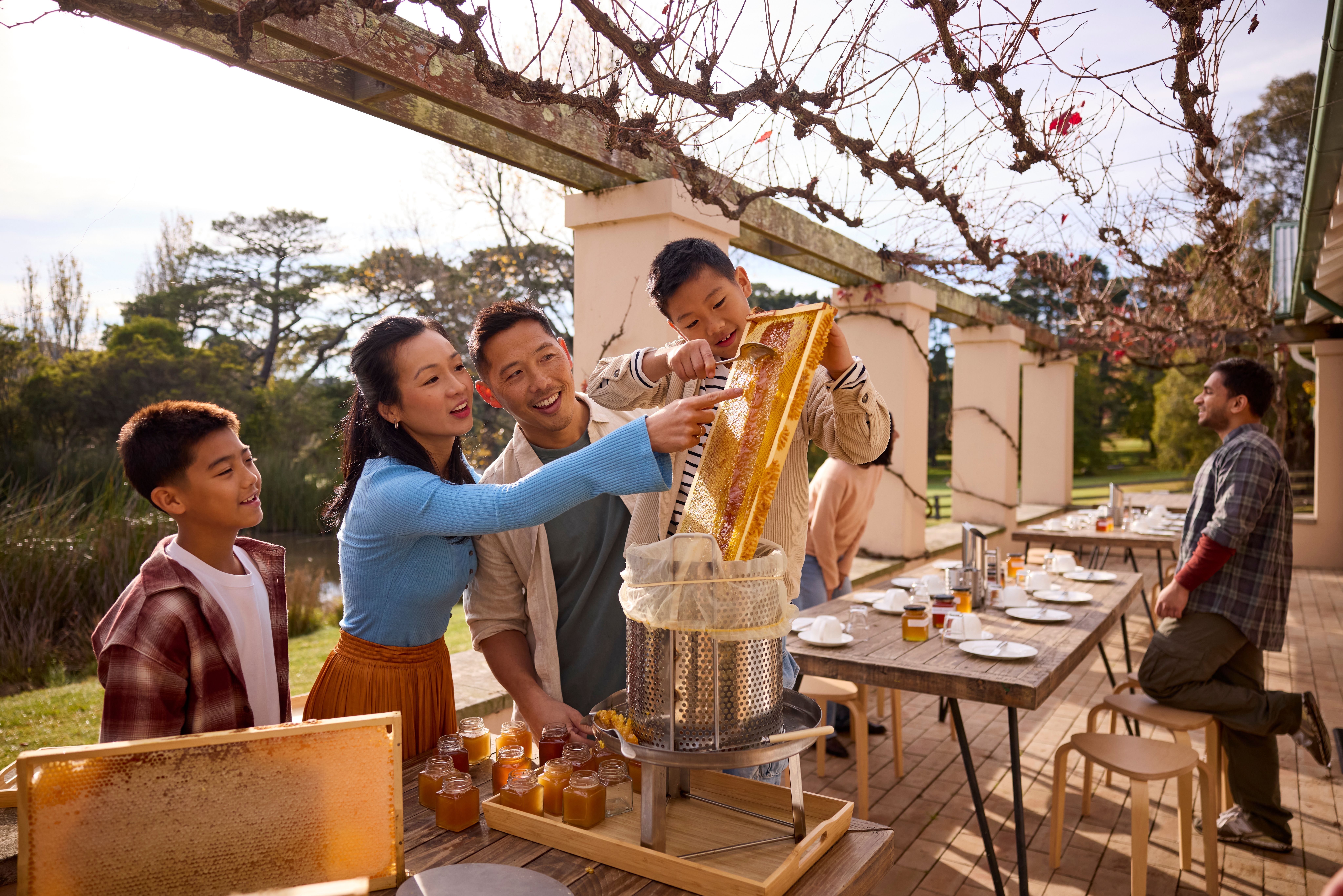Family harvest honey at Bowral Honey Farms