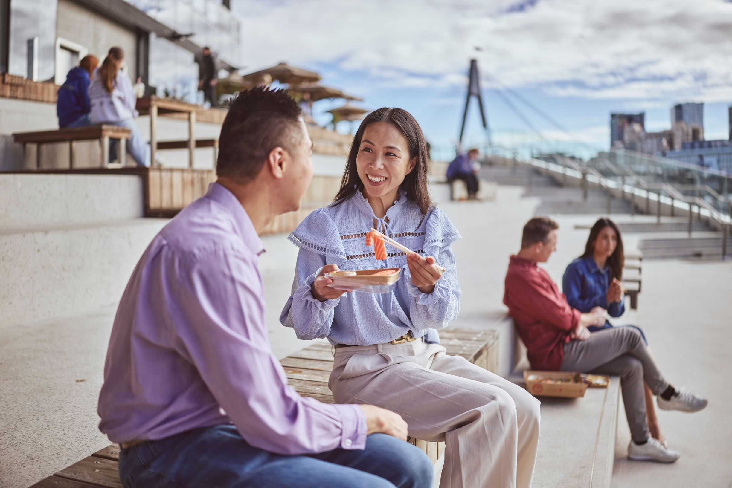 Couple enjoys a seafood meal on the steps of the Sydney Fish Market in Glebe.