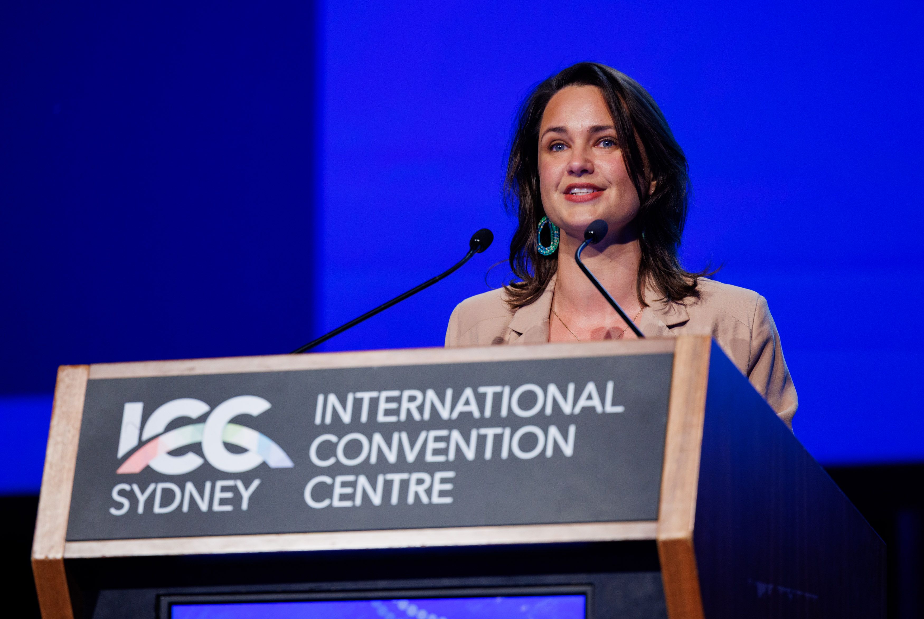 NSW Visitor Economy Forum MC Rae Johnston at the podium