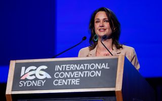 NSW Visitor Economy Forum MC Rae Johnston at the podium