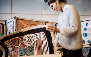 Woman looking at Indigenous art
