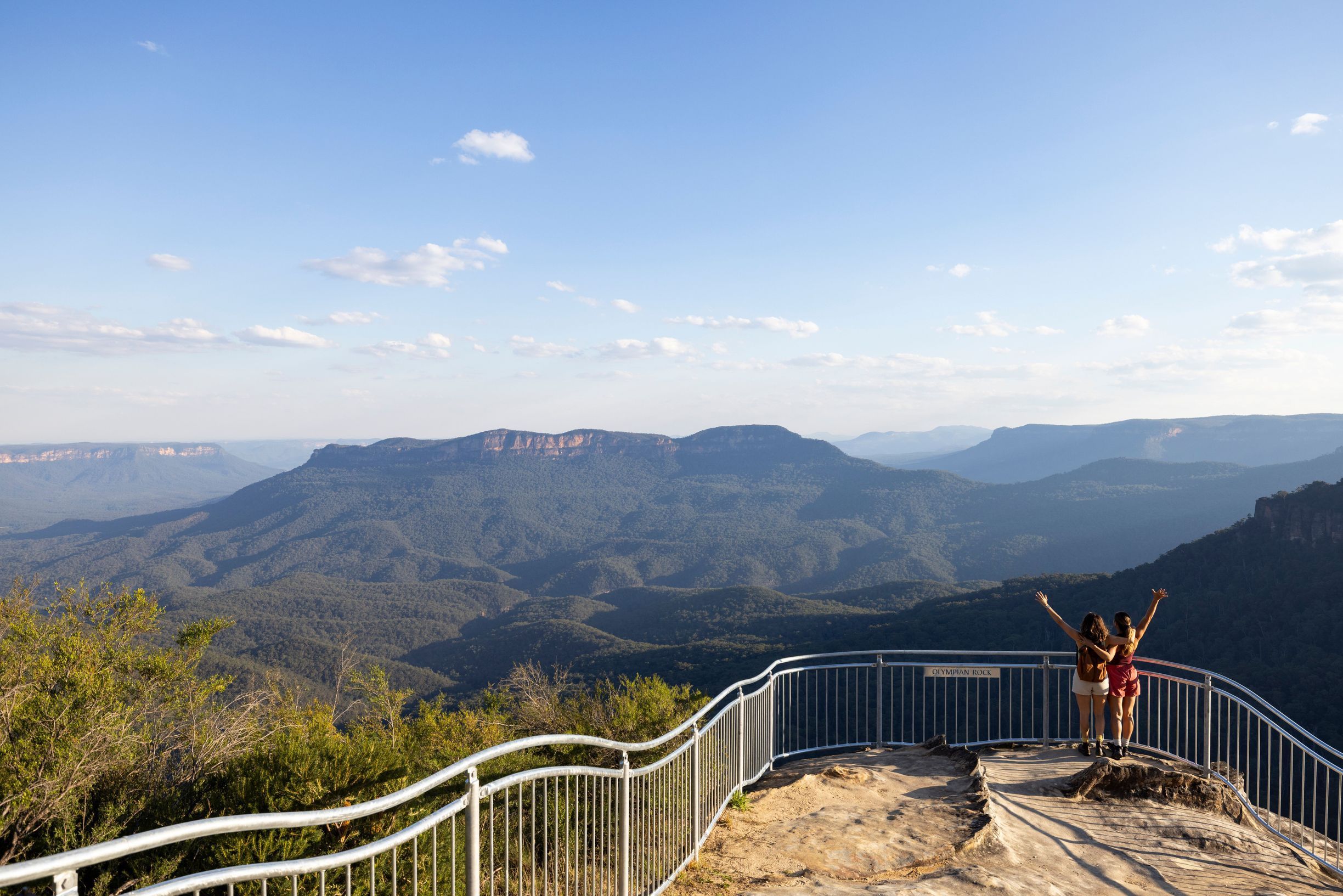 Hikers enjoy the view at the Olympian Rock Lookout, Blue Mountains.