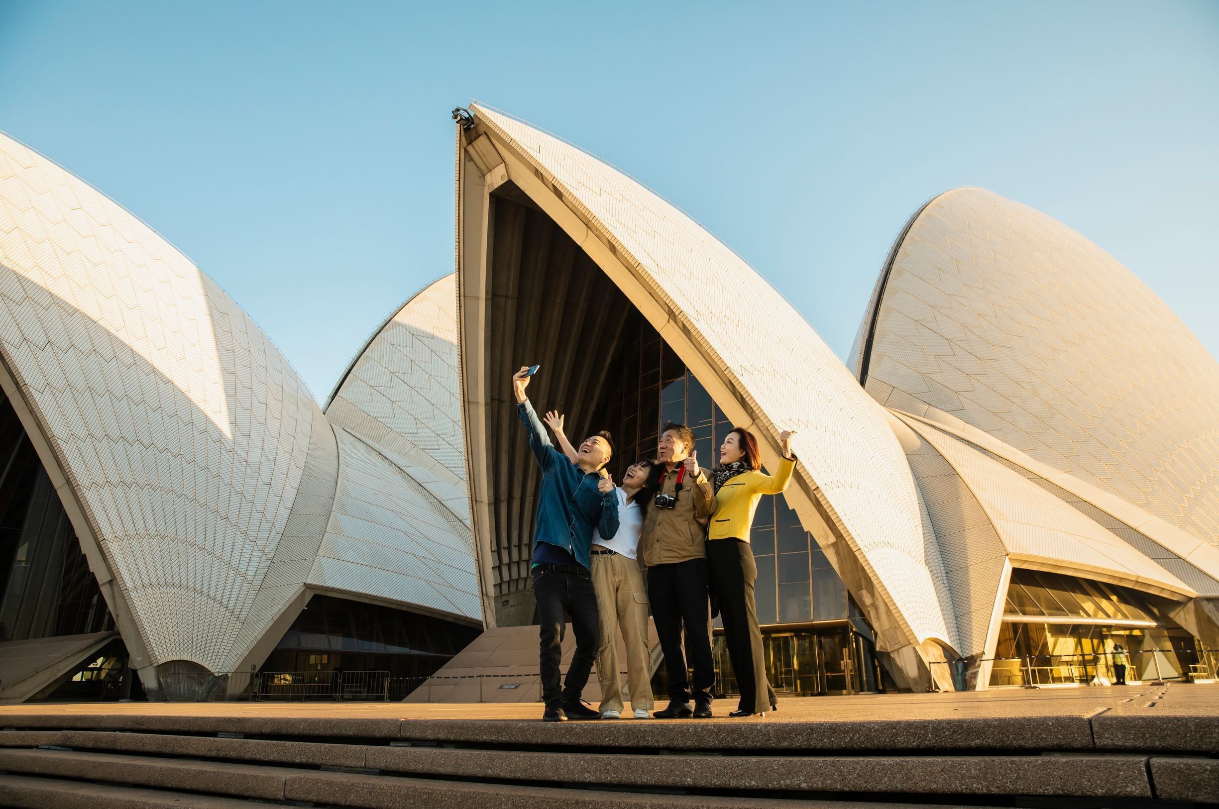 Visitors taking selfie in front of Sydney Opera House sails