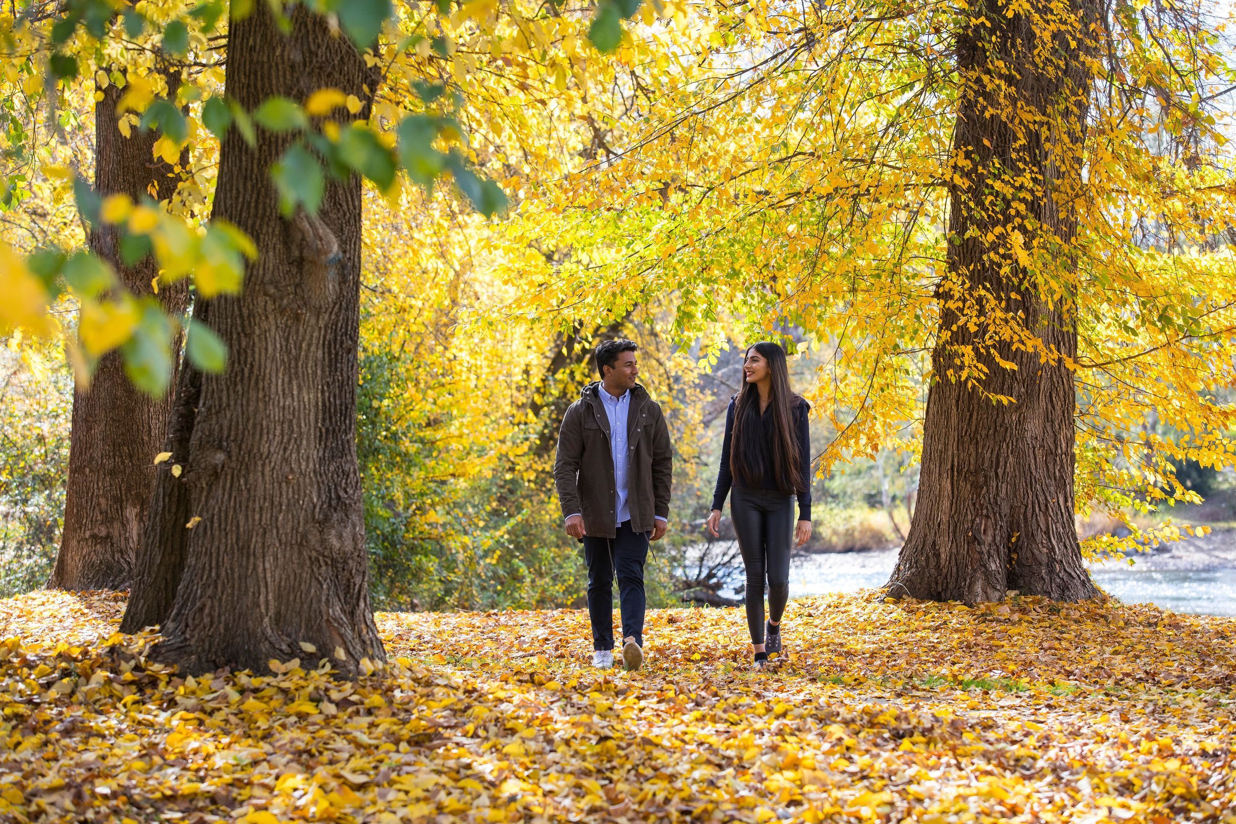 Couple enjoying the autumn colours along the Tumut River walk