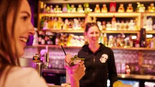 Woman with cocktail at Mexican restaurant