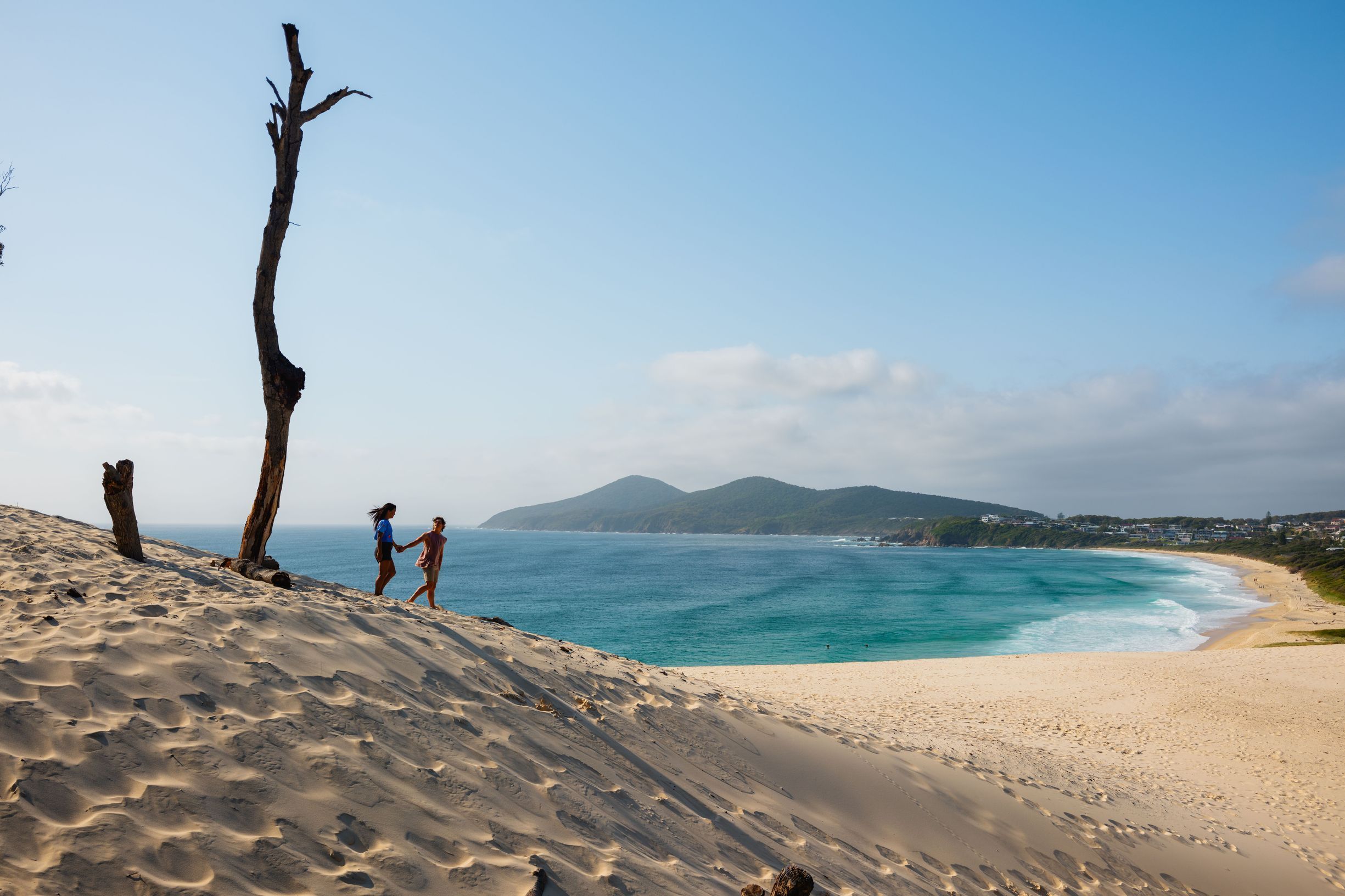 Couple enjoying the stunning views from One Mile Sand Dunes in Forster