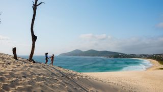 Couple enjoying the stunning views from One Mile Sand Dunes in Forster