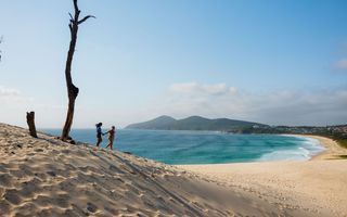 Couple enjoying the stunning views from One Mile Sand Dunes in Forster