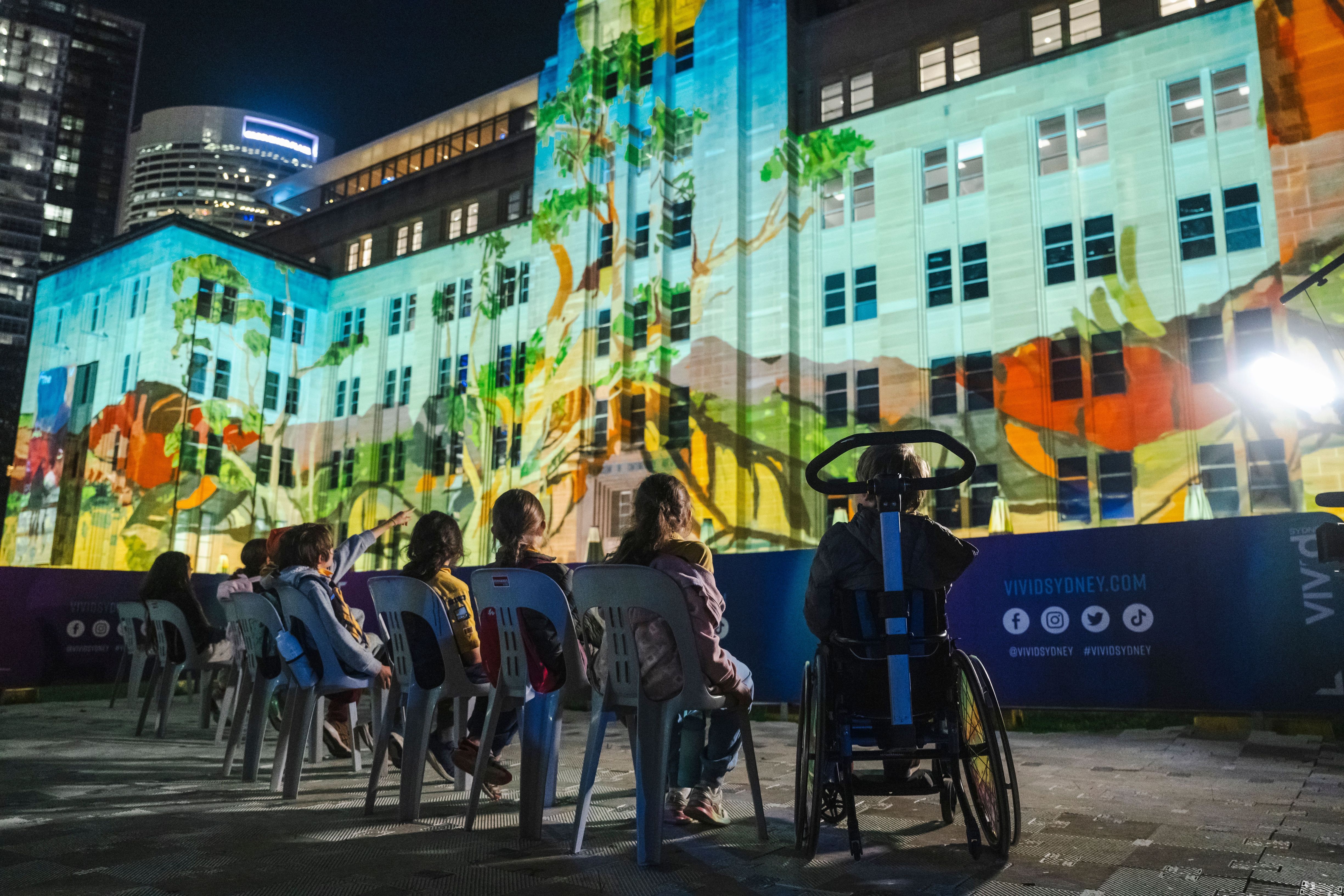 Children watch MCA light projections from accessible area.
