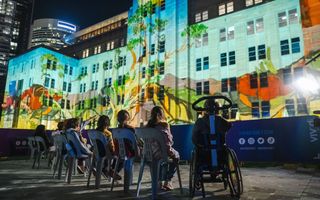 Children watch MCA light projections from accessible area.