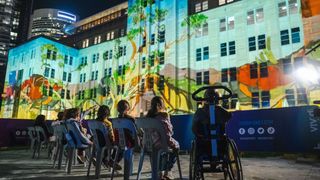 Children watch MCA light projections from accessible area.